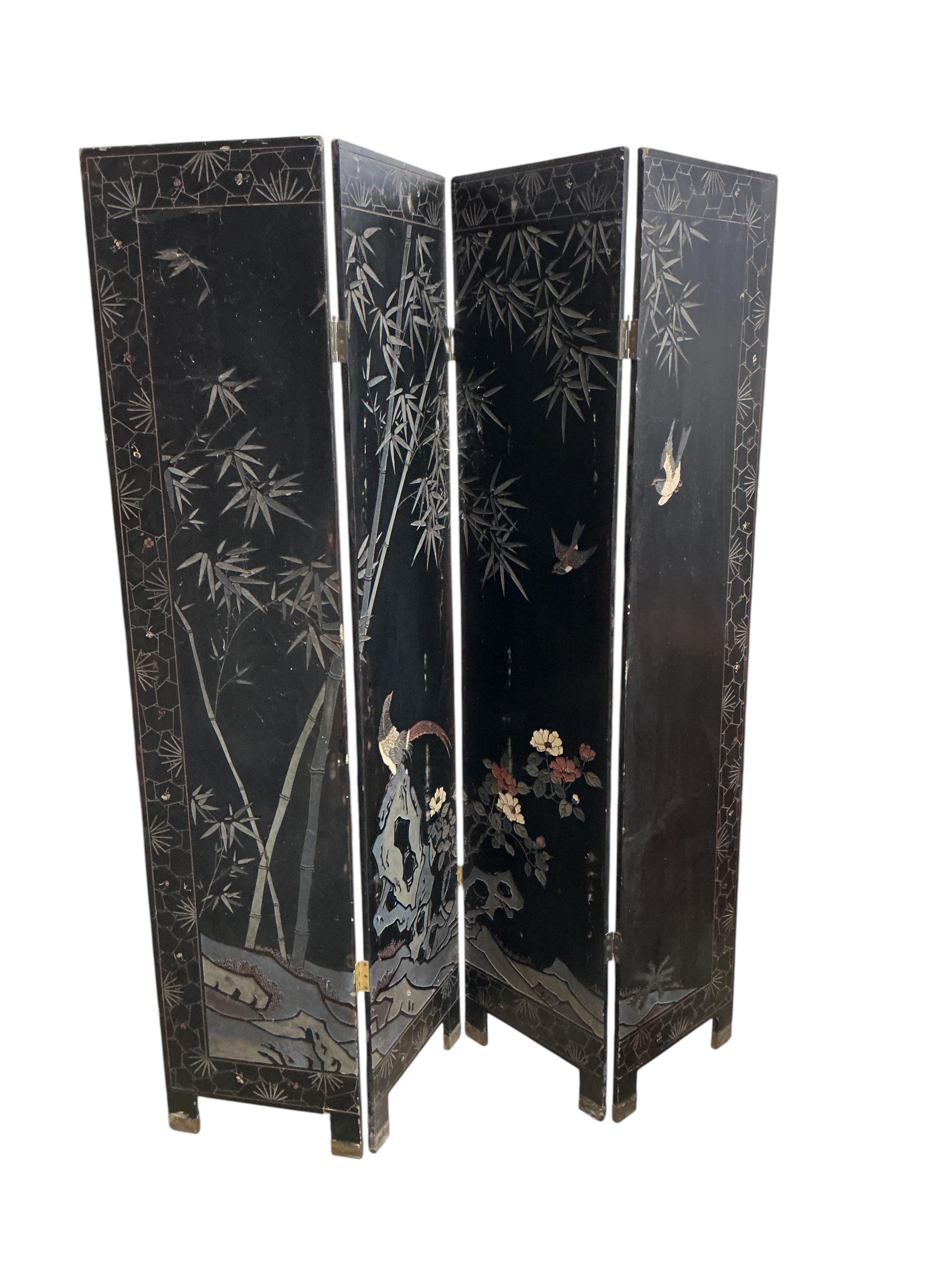 A late 19th century Chinese black lacquer four fold draught screen, each panel width 41cm, height 183cm